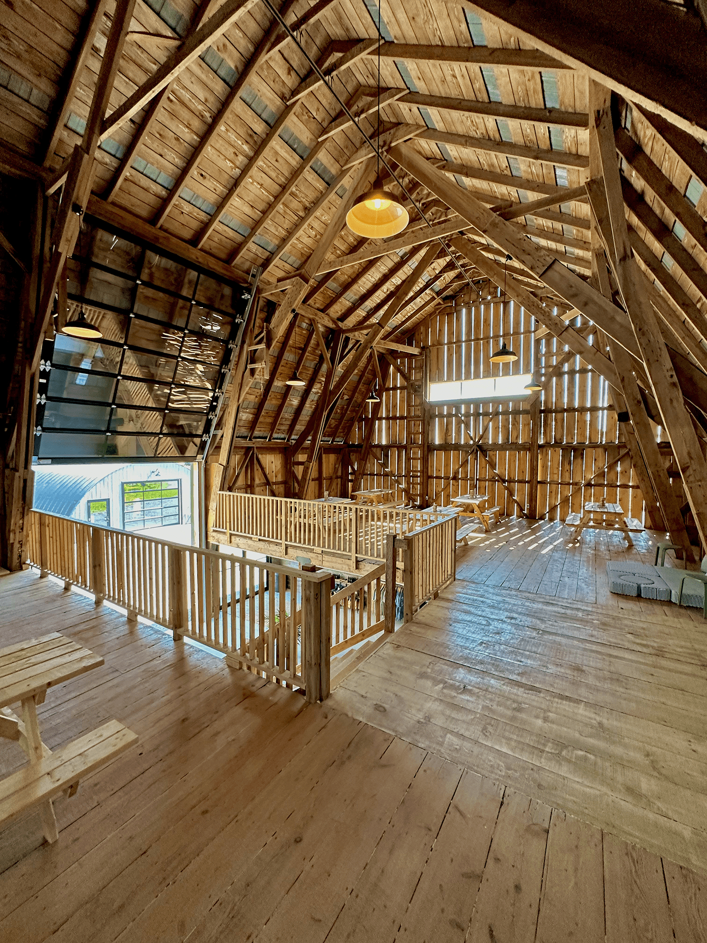 Large distillery barn interior with high ceiling and wooden floor.